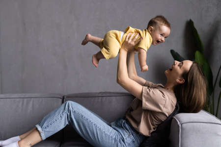 happy loving family. mother playing with her baby in the bedroom.