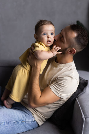 family, parenthood and people concept. happy father with little baby daughter at home