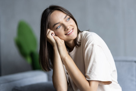 Young woman lying at home living room couchの写真素材