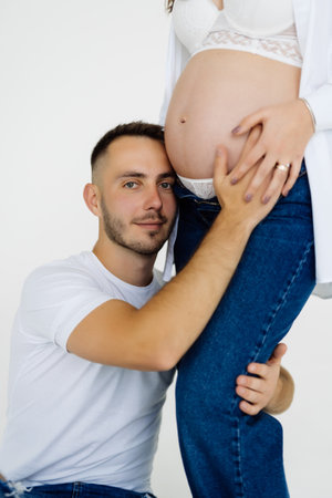 Portrait of isolated cute recently married people pregnant waiting for baby over argent backgroundの写真素材