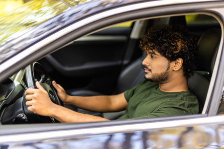 Portrait of an handsome asian business man driving his car