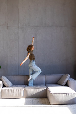 Portrait of happy woman dancing, rejoicing and triumphing, feeling upbeat at home.