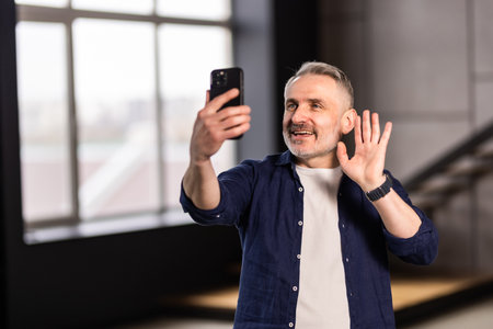 Funky attractive handsome good man take selfie stand inside bright light white room