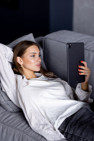 Young woman using digital tablet at homeの写真素材
