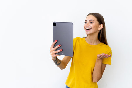 Happy woman chatting via video call and greeting with hand isolated on a white backgroundの写真素材