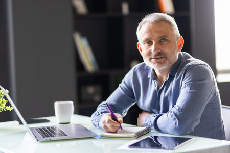 Senior businessman working on laptop computerの写真素材