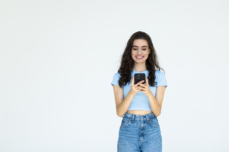 Portrait of a businesswoman using mobile phone isolated over white background