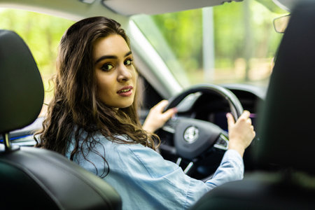 Young beautiful blonde woman smiling happy driving carの写真素材