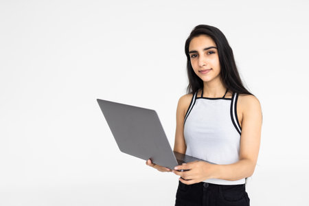 Indian businesswoman or employee using laptop on white background.