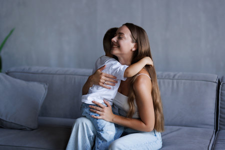 Son is kissing his mother. Mom and son. Happy mother's day! Mother hugging her child. Shot of an adorable little boy affectionately kissing his mother at homeの写真素材