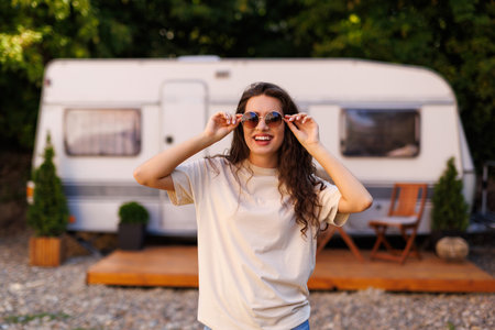 Young woman near motorhome outdoors on sunny dayの写真素材