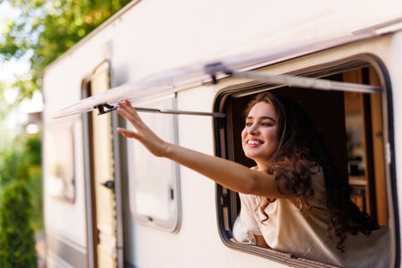 Caucasian woman peeking out of camper window.の写真素材