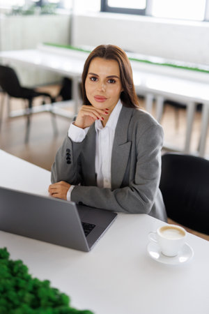Portrait of a beautiful business woman working at a desk with a notebook.