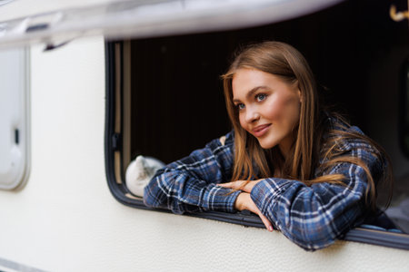 Woman looking out the window of a camperの写真素材