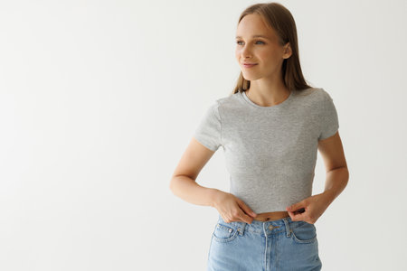 Portrait of self-confident successful business coach with crossed arms isolated on gray studio...