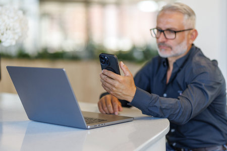 Businessman enjoying coffee and doing his freelance jobの写真素材