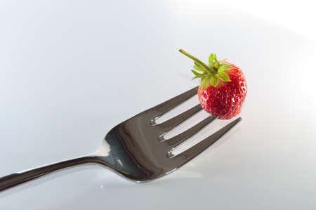 Fork with a strawberry.の写真素材