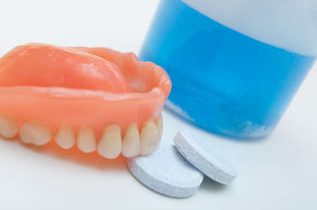 Denture with cleaning tablets and  water glassの写真素材