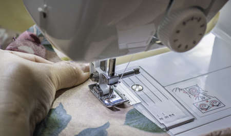 Housemade is using sewing machine to repair her choth
