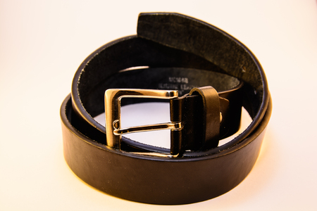 An isolated leather belt. Men belt on the white background.の写真素材