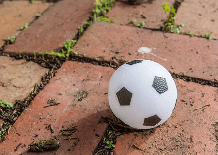 a beautiful black and white soccer ball on the brick surfaceの写真素材