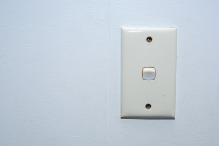 the white electricity switch on the wall in the houseの写真素材