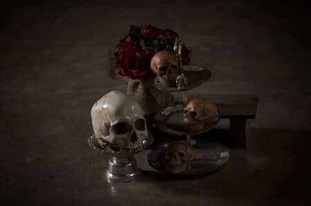 still life style of painting light skulls with red rosesの写真素材