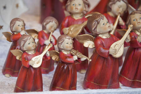christmas angels in red dressed playing instrumentsの写真素材