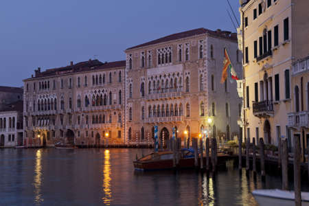 buildings in the light of dawn in the canal grande in veneziaの写真素材