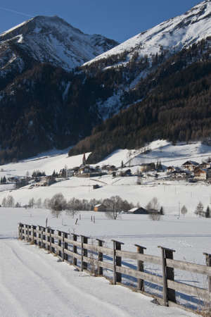 fence in the snowy plateau of kematen in pfitsch, sudtirolの写真素材