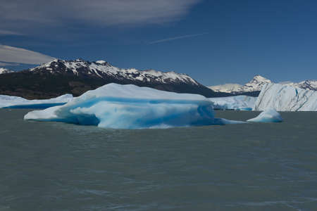 Spectacular blue iceberg floating on the Lake Argentino in the Los Glaciares National Park,...