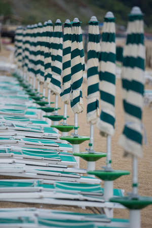 Row of beach umbrellas in a beach resort of Marcelli di Numana in Marcheの写真素材