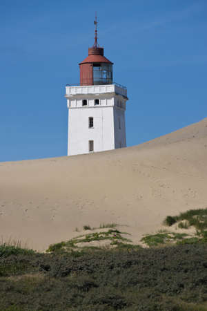 Lighthouse on a sand dune in Rubjerg Knude in Denmarkの写真素材