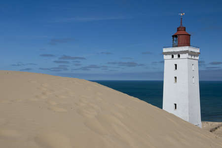 Lighthouse on a sand dune in Rubjerg Knude in Denmarkの写真素材