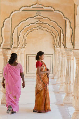 AMBER, INDIA - 20 OCTOBER 2013 - Unidentified women under the arches at the Amber Fort, magnificent fortified palace  near Jaipur, Rajasthan, India  This maharajah residence situated upon Maota  Lake became in 2013 Unesco world heritage site のeditorial素材