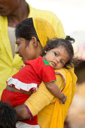 JODHPUR, INDIA - 19 OCTOBER 2013 - Unidentified indian mom holding a little girl on her arm のeditorial素材