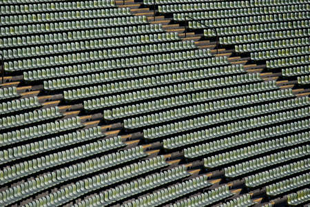 Rows of green seats in a stadiumの写真素材