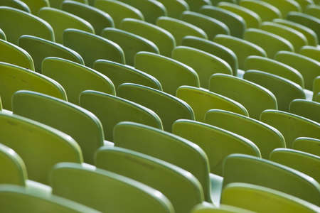 Rows of green seats in a stadiumの写真素材