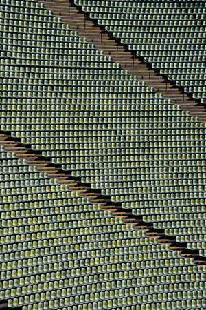 Rows of green seats in a stadiumの写真素材