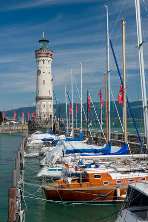 The lighthouse and the bavarian lion at the entrance of the port of Lindau, a picturesque village on the bavarian shore of Constance Lake のeditorial素材