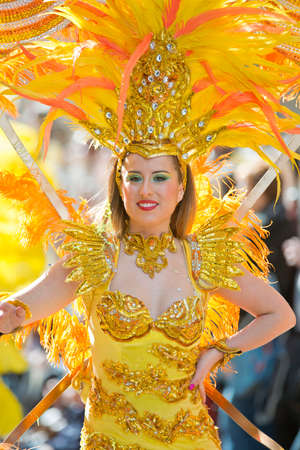 MENTON, FRANCE - 2 MARCH 2014 - Unidentified woman dressed as dancer marching during the parade of the Lemon Festivaのeditorial素材