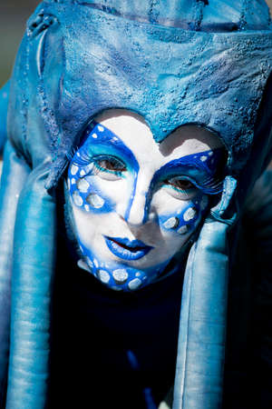 MENTON, FRANCE - 2 MARCH 2014 - Unidentified woman masked during the parade of the Lemon Festivaのeditorial素材