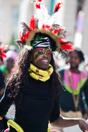 MENTON, FRANCE - 2 MARCH 2014 - Unidentified woman masked during the parade of the Lemon Festivaのeditorial素材