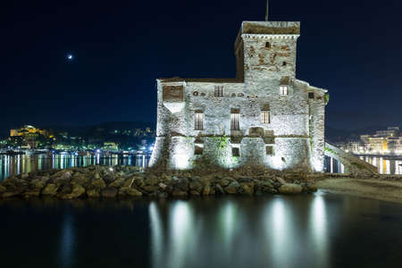 The ancient castle of Rapallo, built on the ligurian sea illuminated by night.のeditorial素材