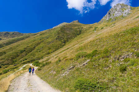 Couple of hikers in Prato Nevoso in the Ligurian Alps, Piedmont, during the summer season.の写真素材
