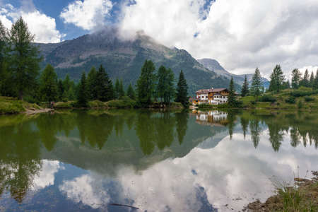 Reflection in a little lake situated at Passo San Pellegrino, in the Dolomitesの写真素材
