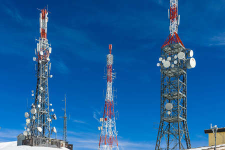 Telecommunications tower at the top of the snowy mountain of Val di Susa.