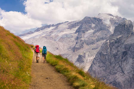 Two hikers on a the trail Viel dal Pan, facing Marmolada in the Dolomitesのeditorial素材