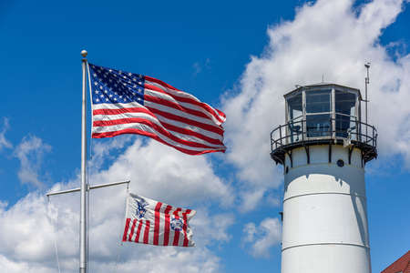 The lighthouse of Chatham and the american flag wavingの写真素材