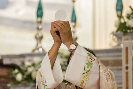 During the christian mass a priest celebrates the rite of the communion